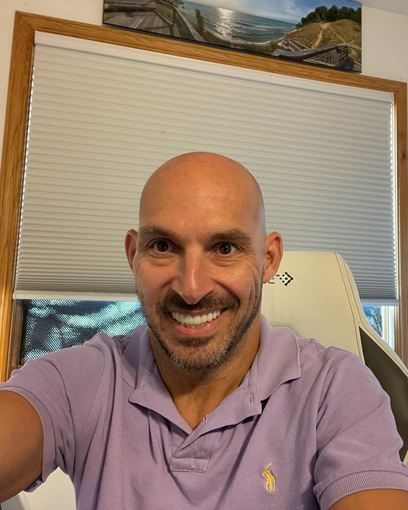 Jeff Luiz, smiling, in his home office